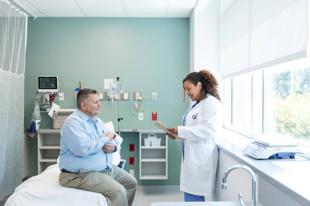 Female physician talking to her patient about obesity